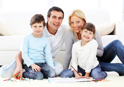Family sitting by couch Family sitting by couch